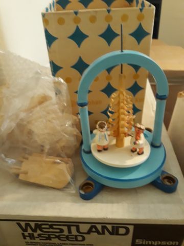 A decorative musical box with a wintry scene and small figures