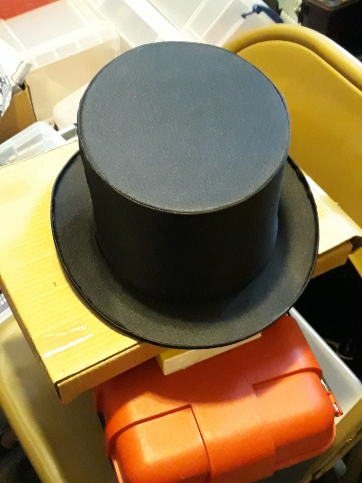 A classic black collapsible top hat from Dad's magic collection